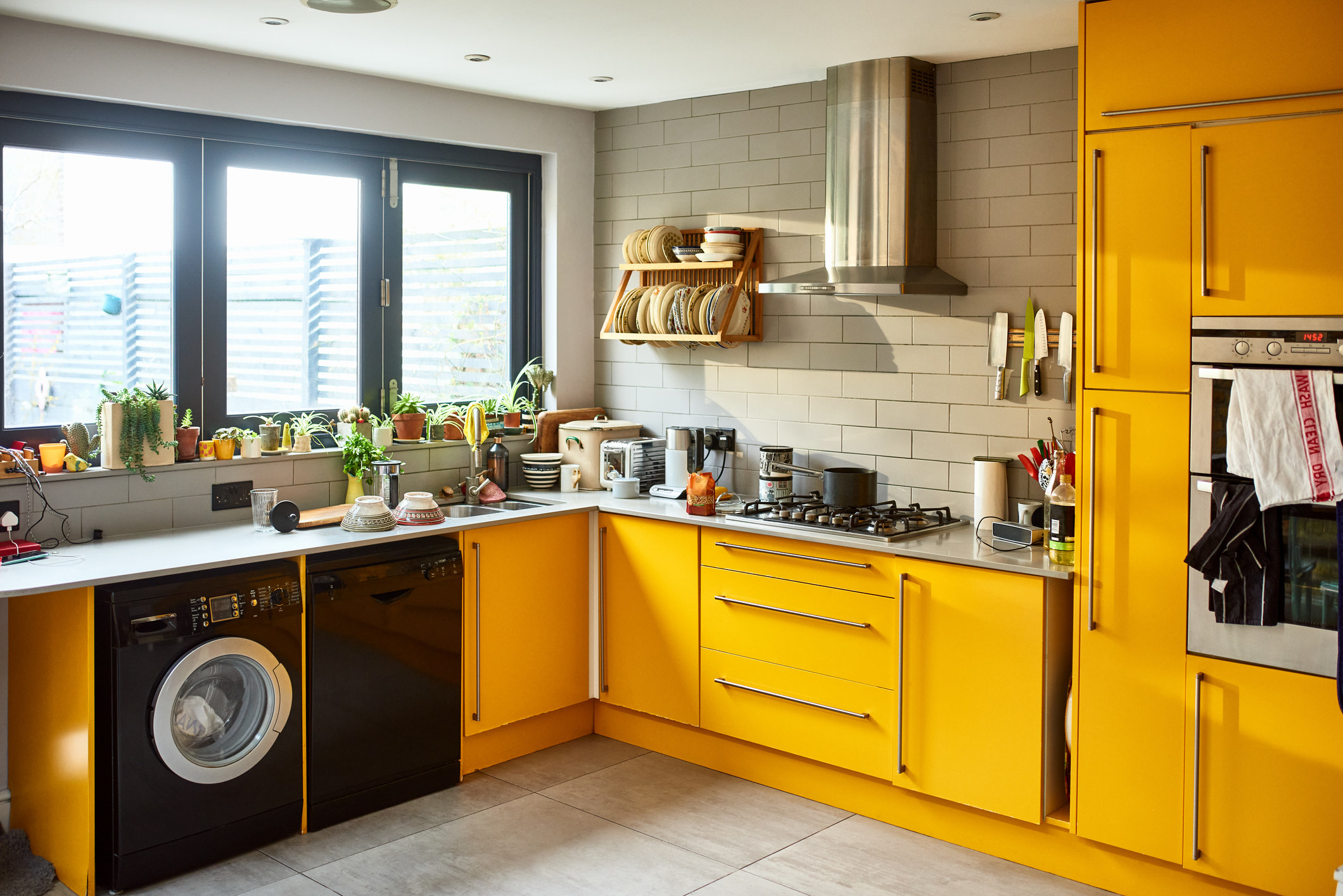 Modern mustard yellow domestic kitchen.