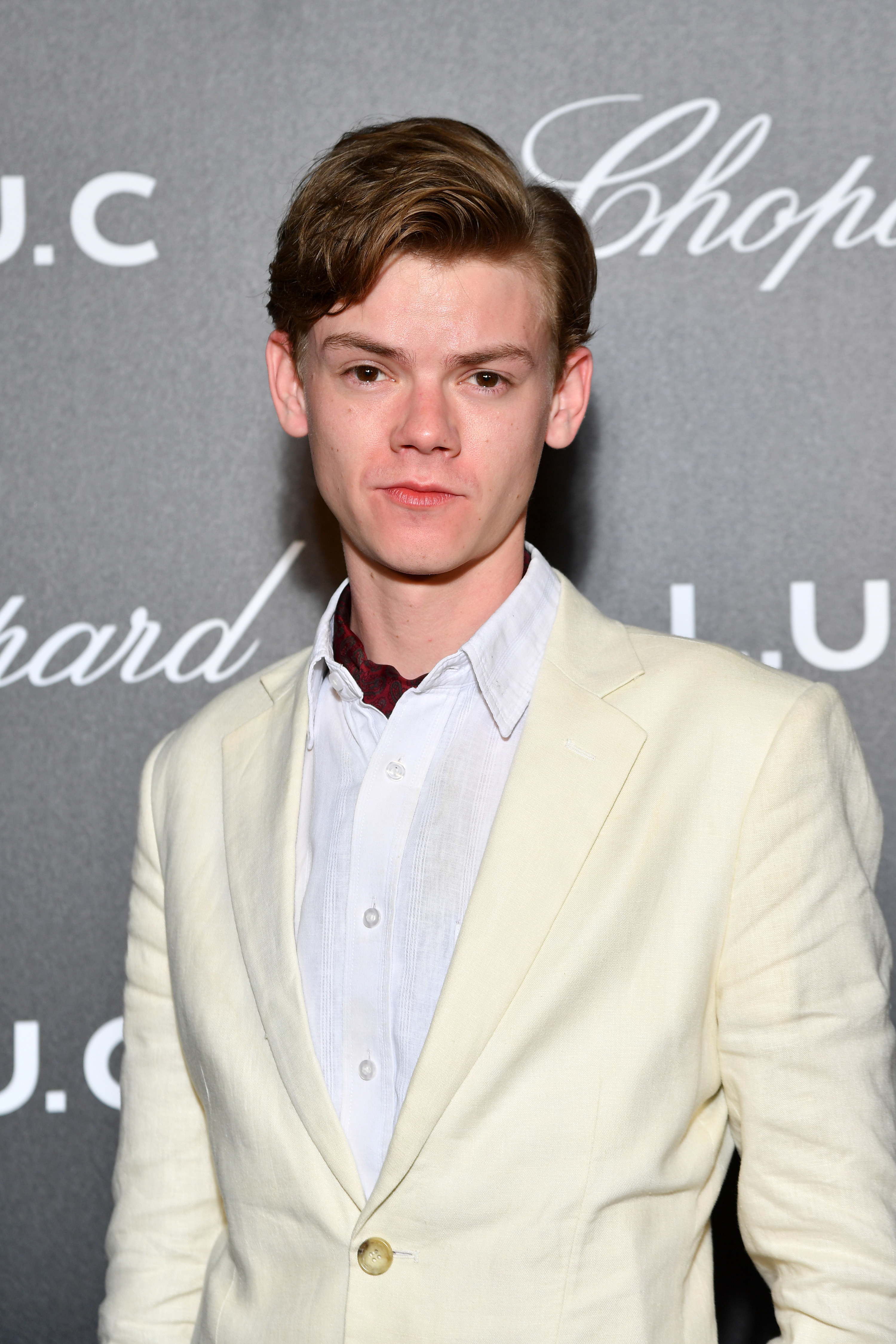 Thomas in a casual shirt and jacket on the red carpet