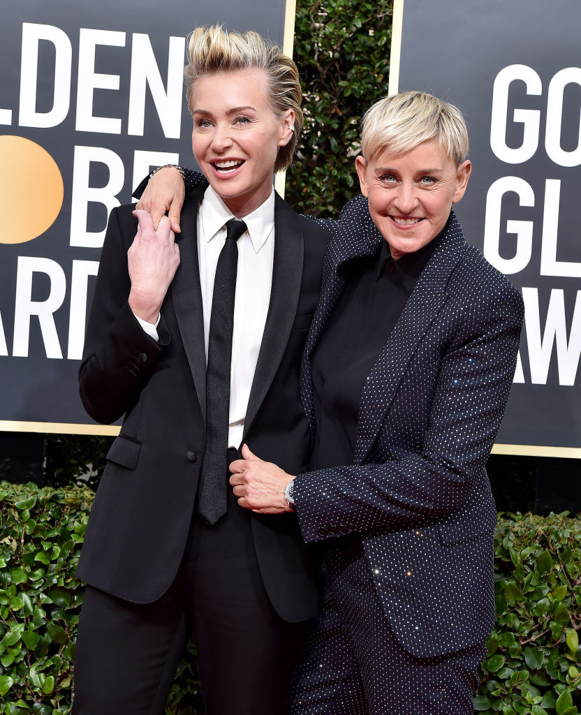 Rossi and DeGeneres with their arms around each other, smiling