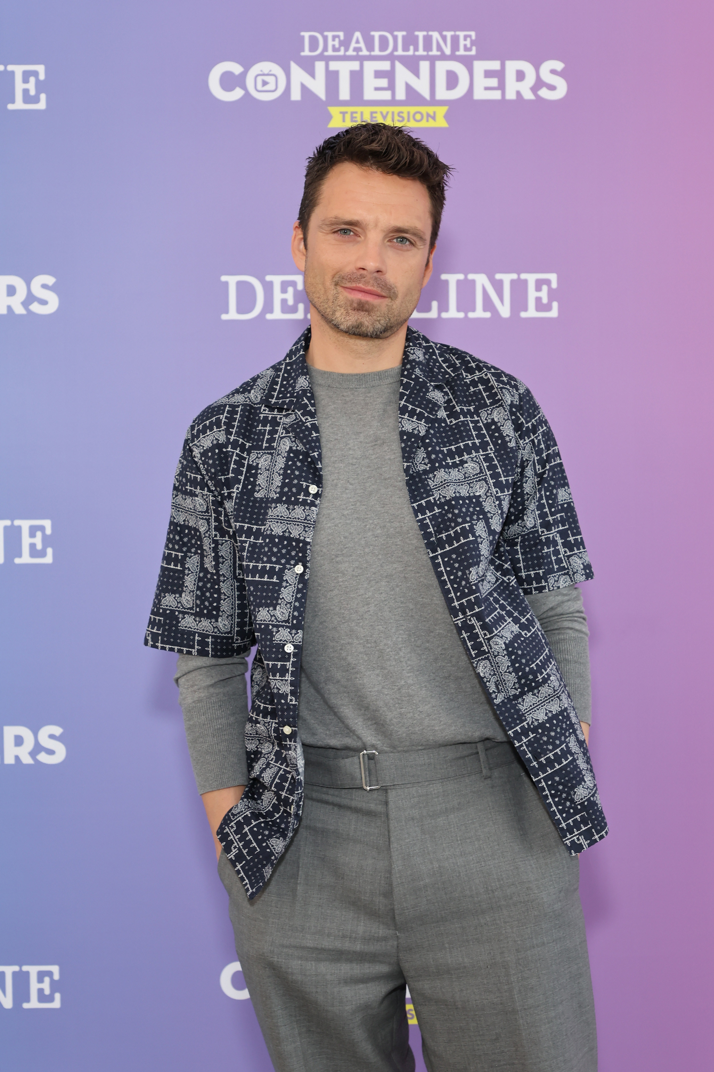 Sebastian on the red carpet in casual pants, top, and overshirt