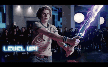 Scott Pilgrim with a light saber-like weapon and text overlay that says &quot;level up&quot;
