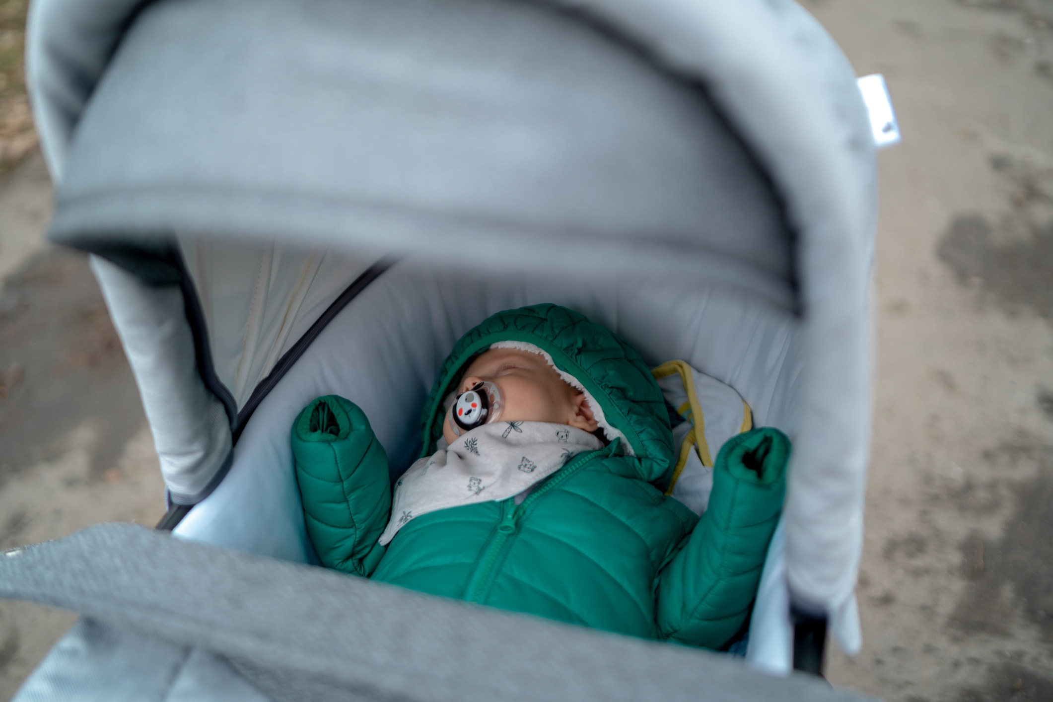 A baby sleeping in a stroller.