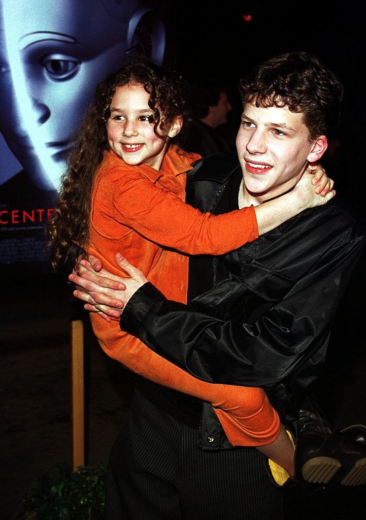 A teenage Jesse carries child Amanda at the event; both are smiling widely