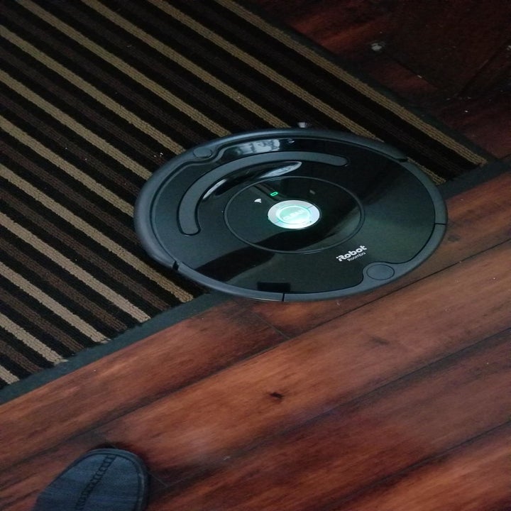 a reviewer's robot vacuum crossing from hardwood to carpet