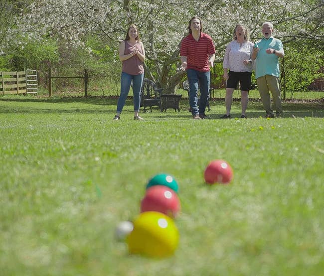 Family playing bocci ball