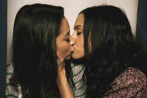 A close up of Emily and Maya kissing in a photobooth