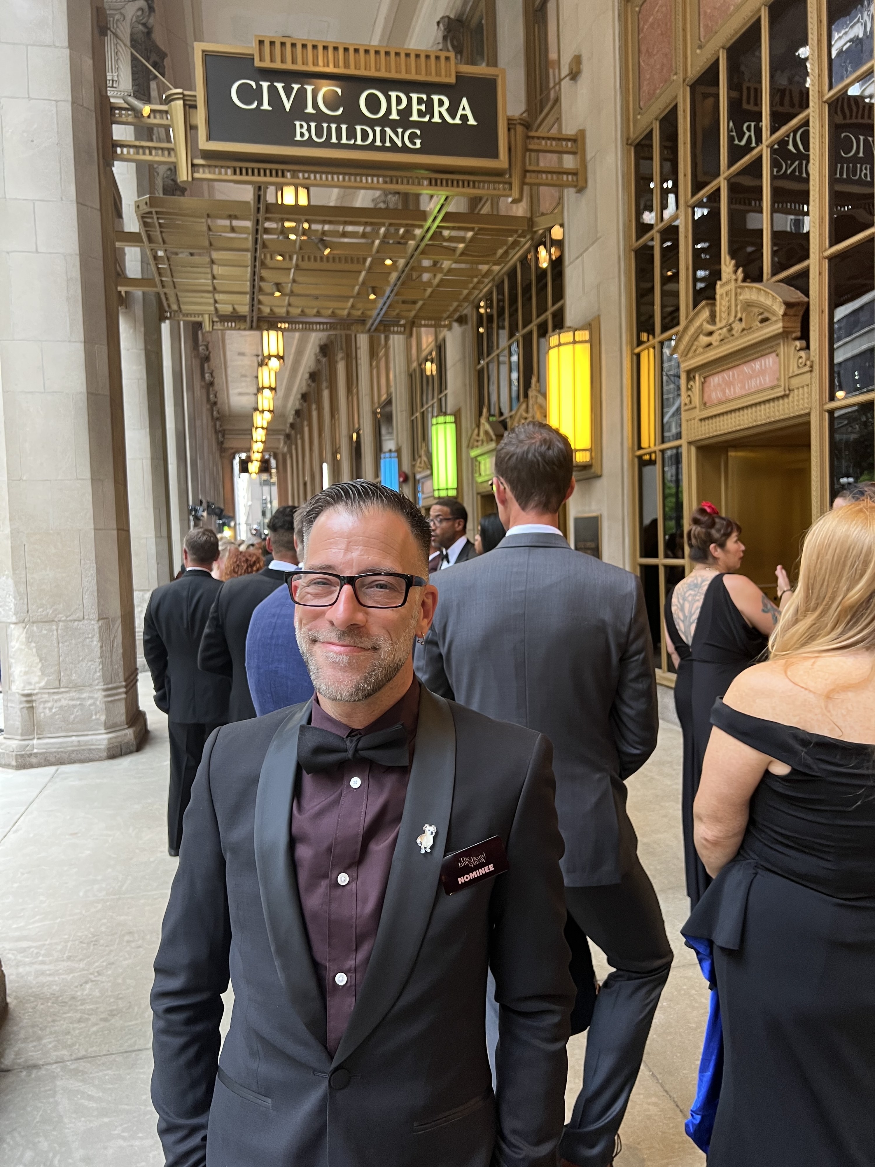 Gregory Leon standing in front of JamesBeard Awards