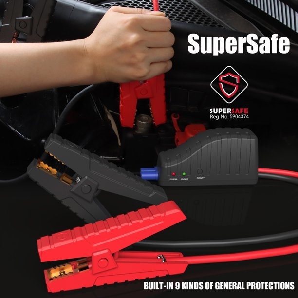 The battery pack connected to car battery to provide a jump. Text on image reads &quot;supersafe. built-in 9 kinds of general protections&quot;