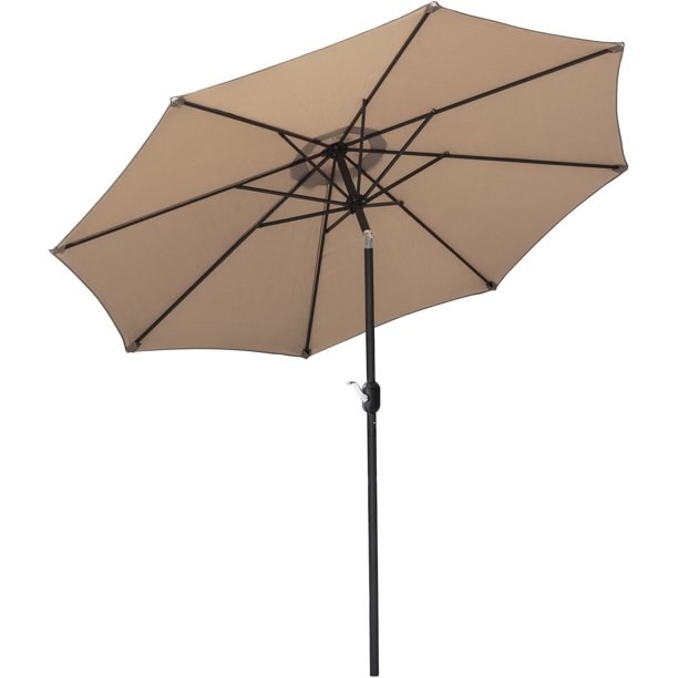 The tan umbrella tilted at an angle