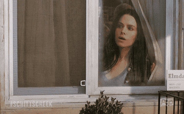 woman looking out of her window