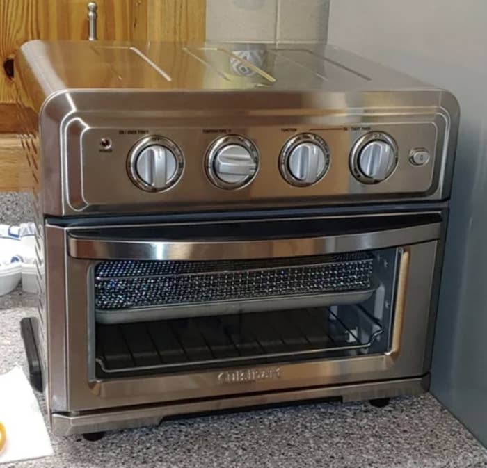 Reviewer&#x27;s photo of the stainless steel oven resting on counter