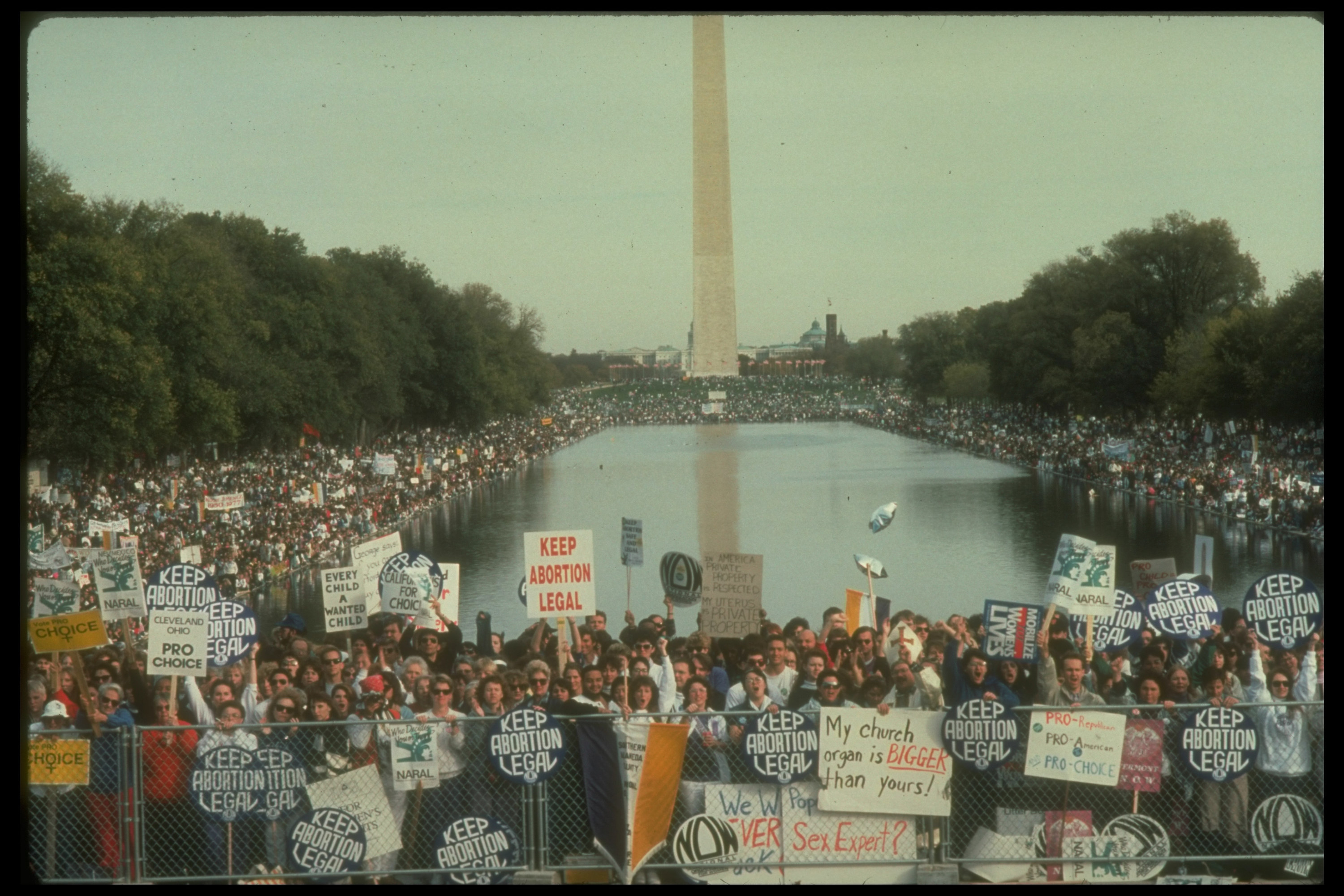 Protesters crowd the space around the Washington Monument and reflecting pool