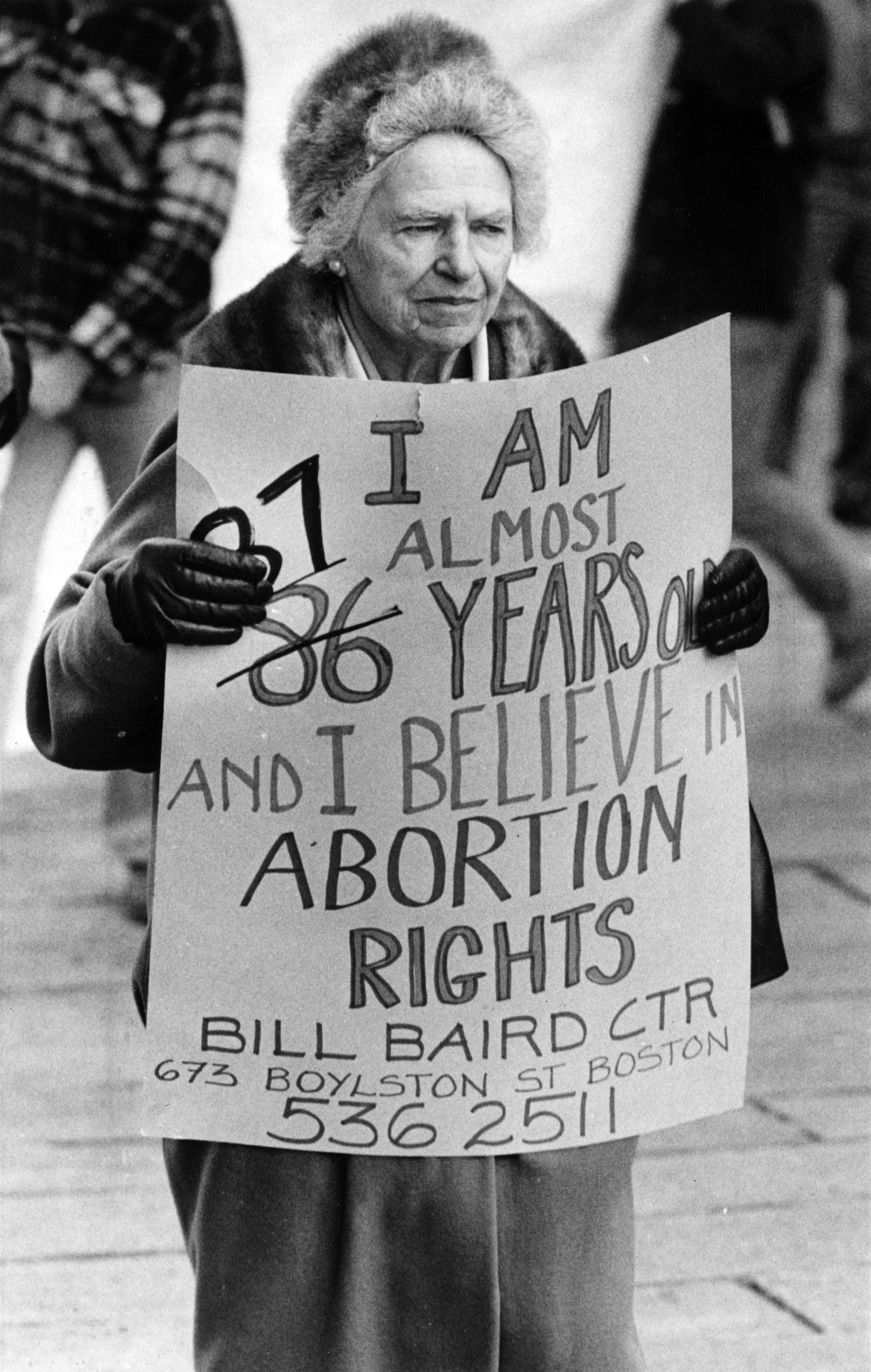 A protester holds a sign reading &quot;I am almost 87 years old and I believe in abortion rights&quot;