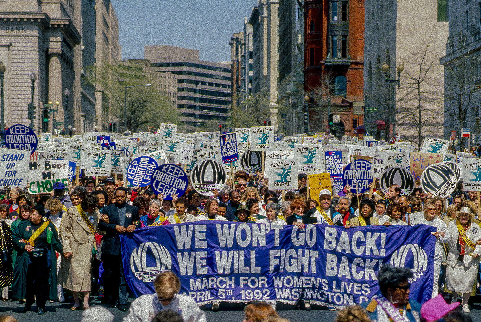 Demonstrators hold a banner reading &quot;we won&#x27;t go back, we will fight back&quot;