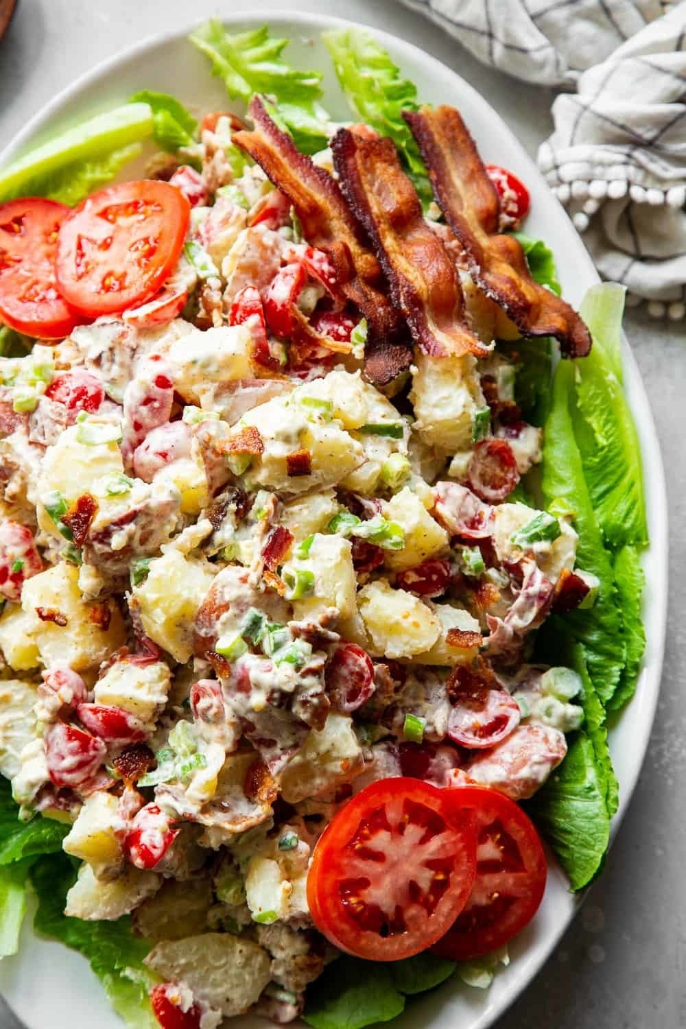 Potato salad with bacon, lettuce and tomato.