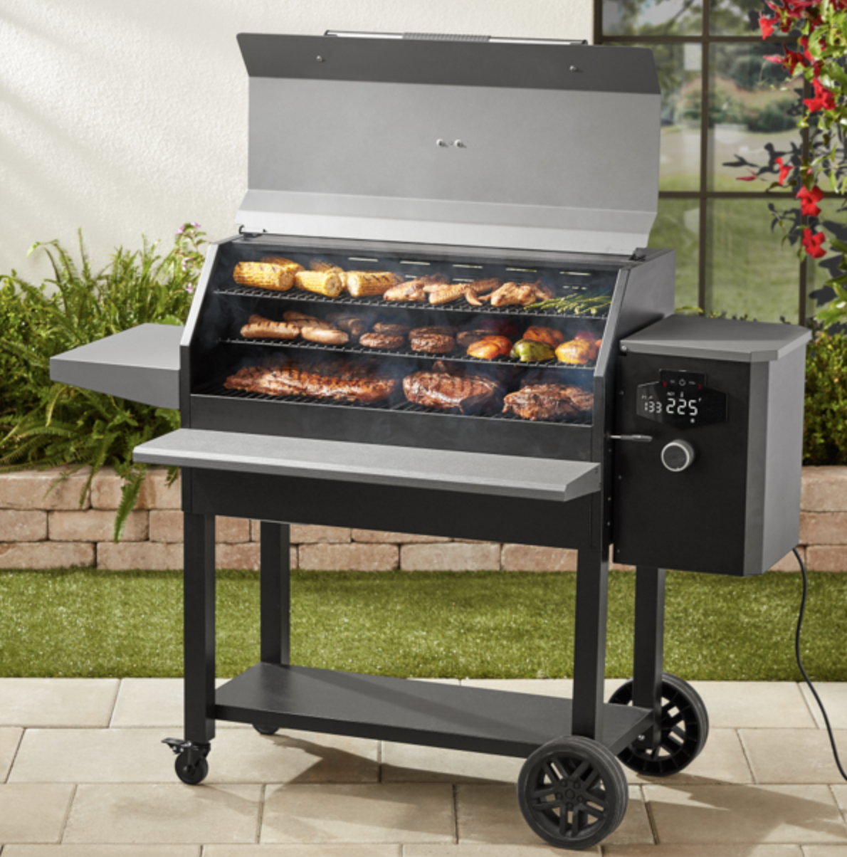 black grill and smoker heating up veggies and meat