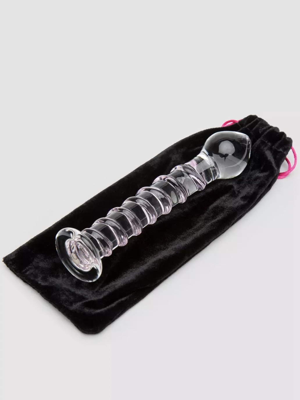 The glass dildo resting on black pouch