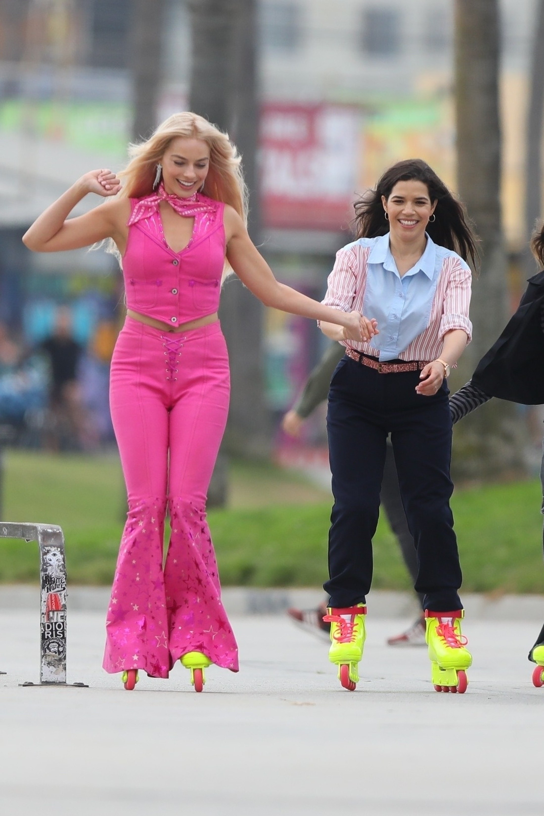 Margot rollerblading in her two-piece Western outfit with America, who is wearing normal pants and a button-down shirt