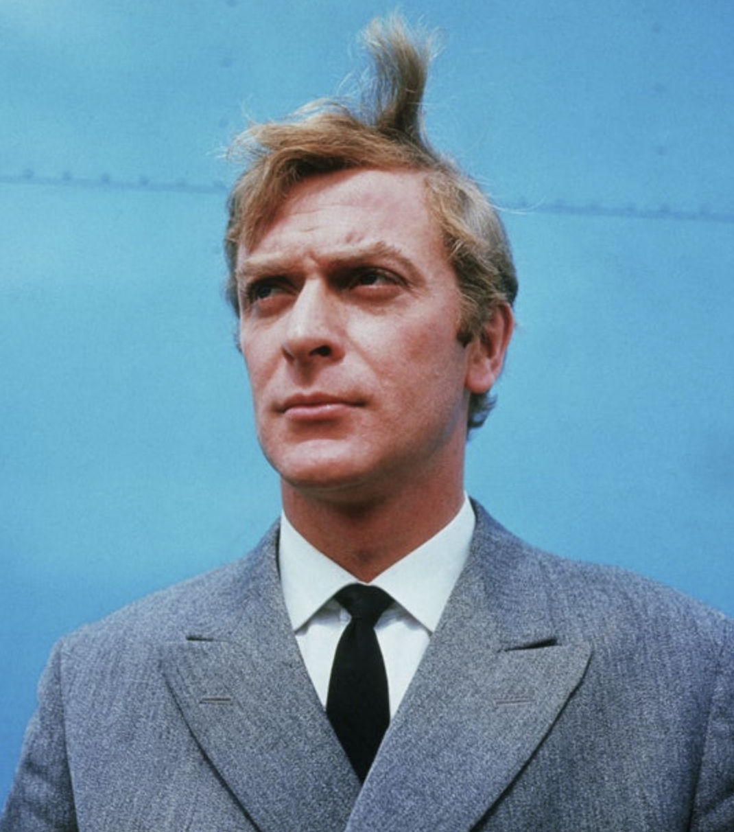 Michael Caine in a grey suit in 1965