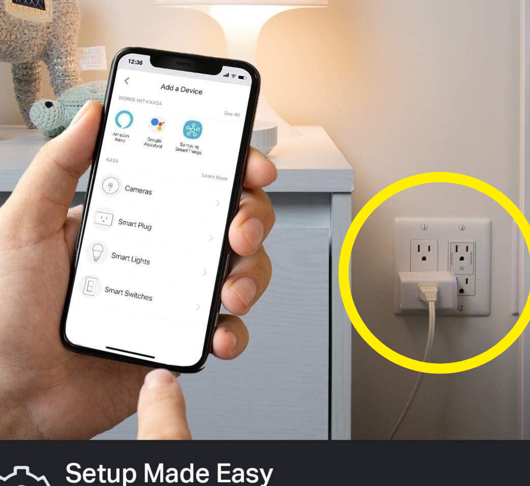 a person holding a phone next to the smart plug, which is circled