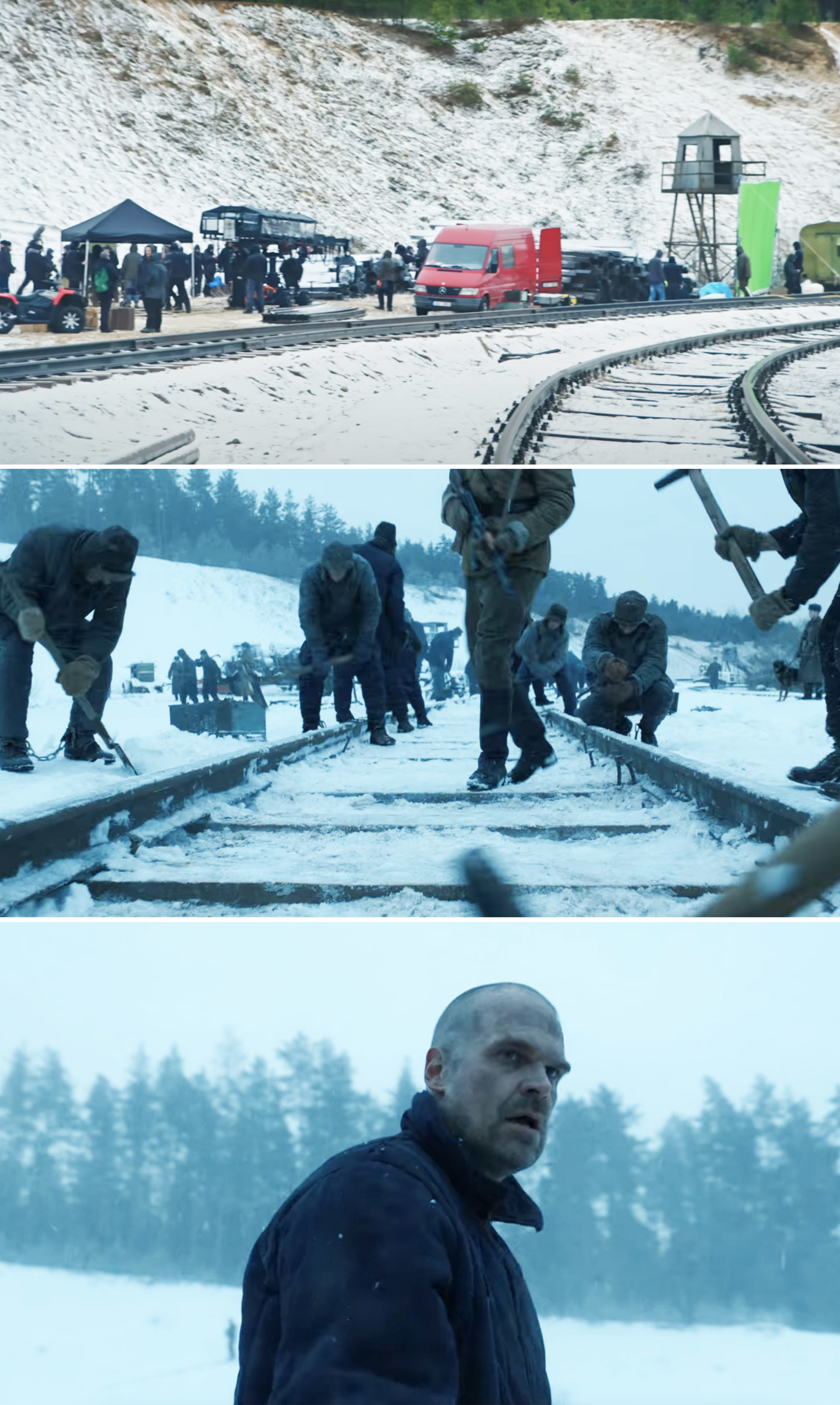 Crew members standing in the snow and near train tracks