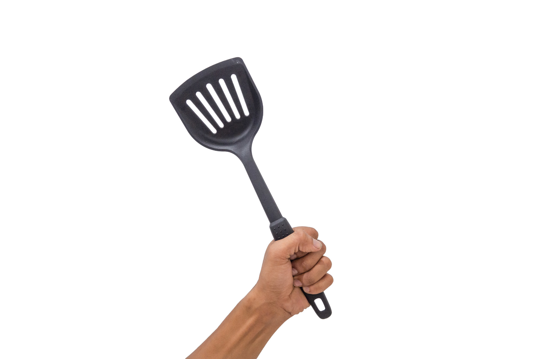 A hand holds a spatula