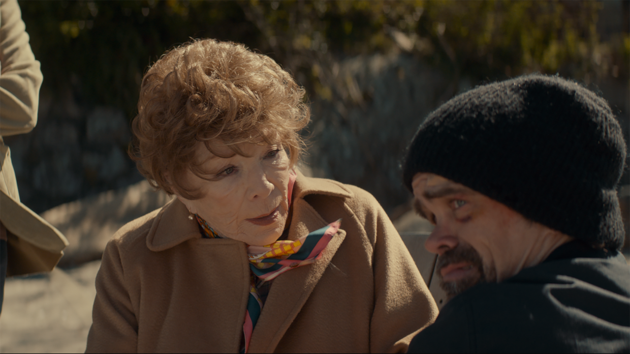 Shirley MacLaine and Peter Dinklage talk on a beach