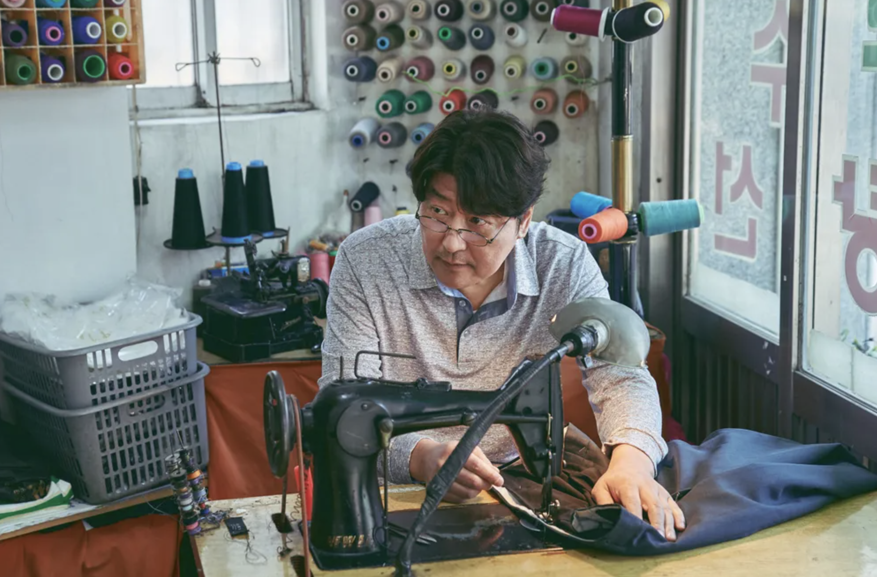 Song Kang-ho at a sewing machine