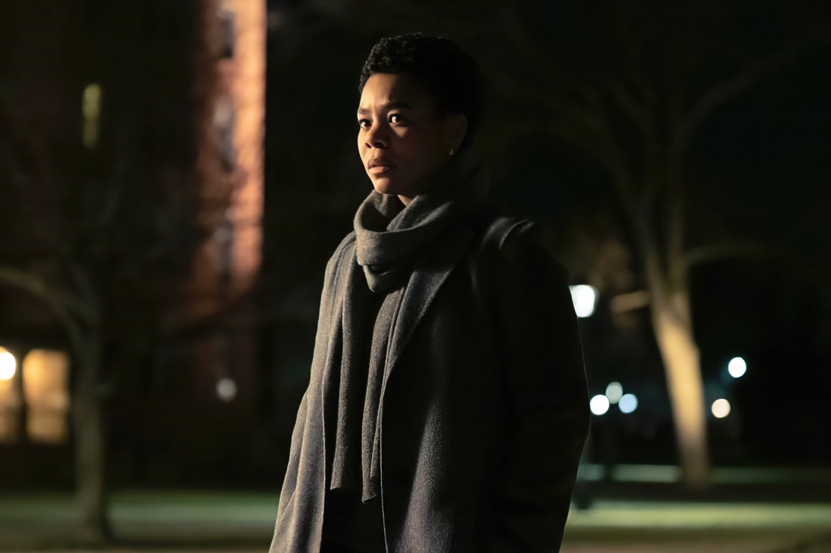 Regina Hall stands on a campus at night