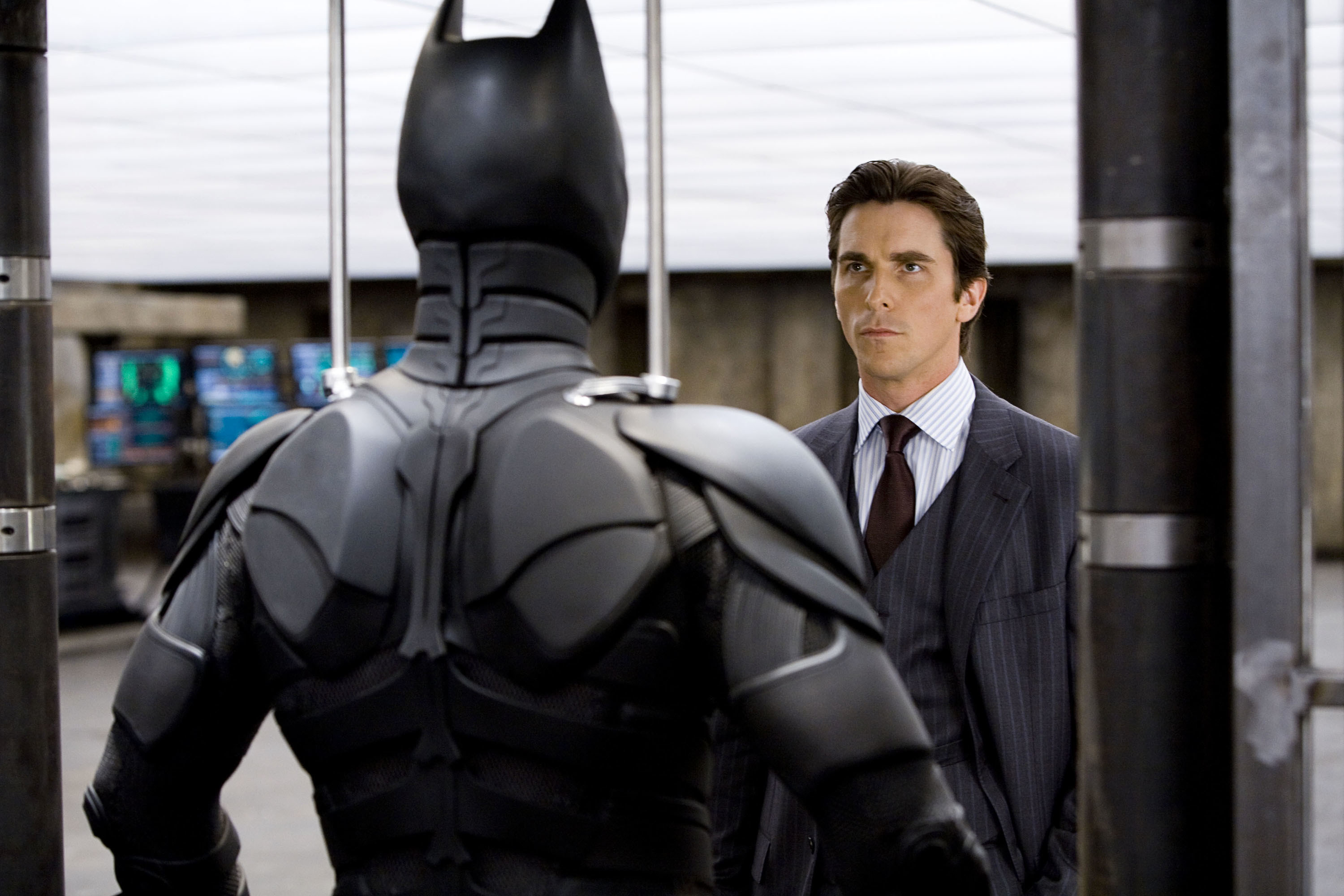 Christian Bale looking at Batman in the mirror