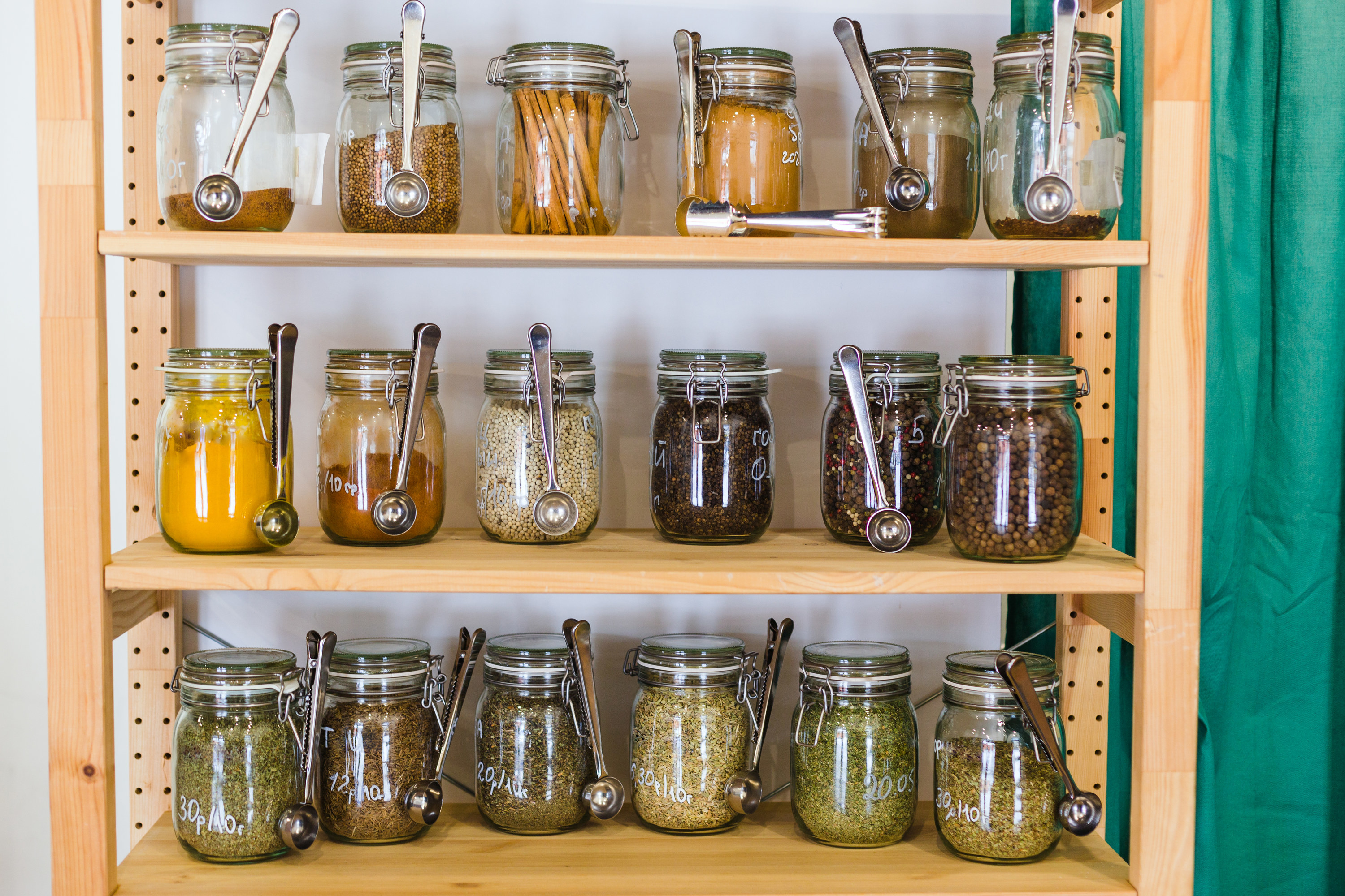Spice rack with glass jars and tiny metal spoons