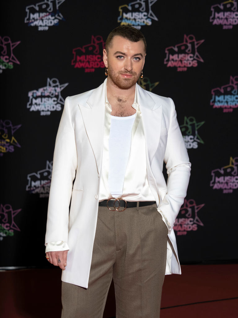 Sam Smith posing with their hand in their pocket at a music awards event