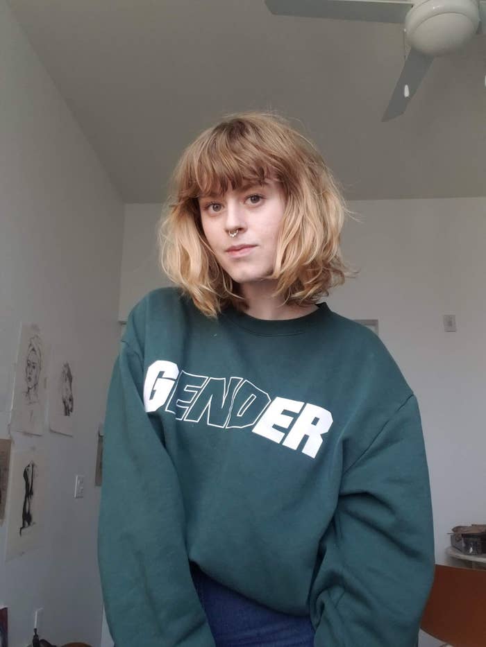 Sydney wearing a sweatshirt that says &quot;Gender&quot; with &quot;end&quot; outlined
