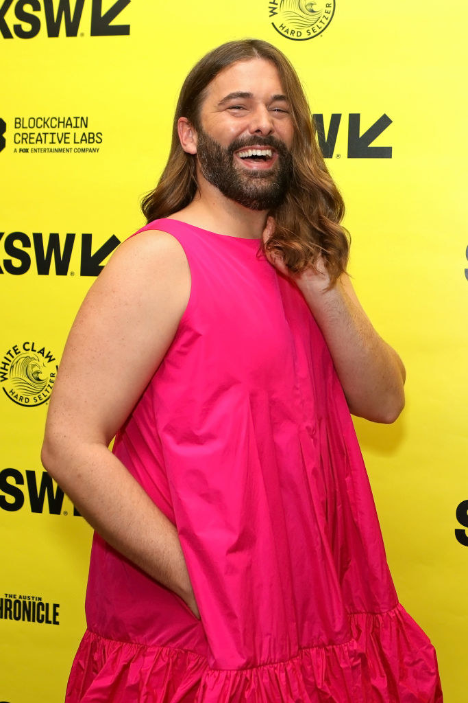 Jonathan Van Ness laughing by a step and repeat