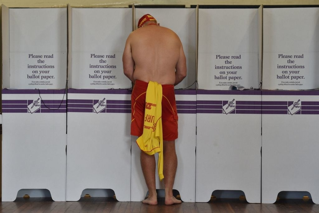 A surf lifesaver casts his ballot in the Wentworth by-election in Bondi Beach in Sydney