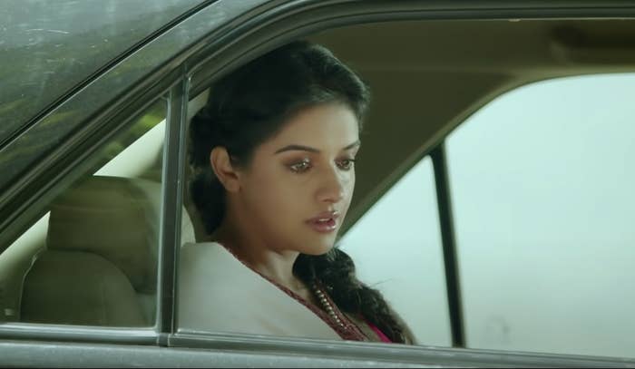 Asin in a still from the movie All Is Well. She's sitting in a car.