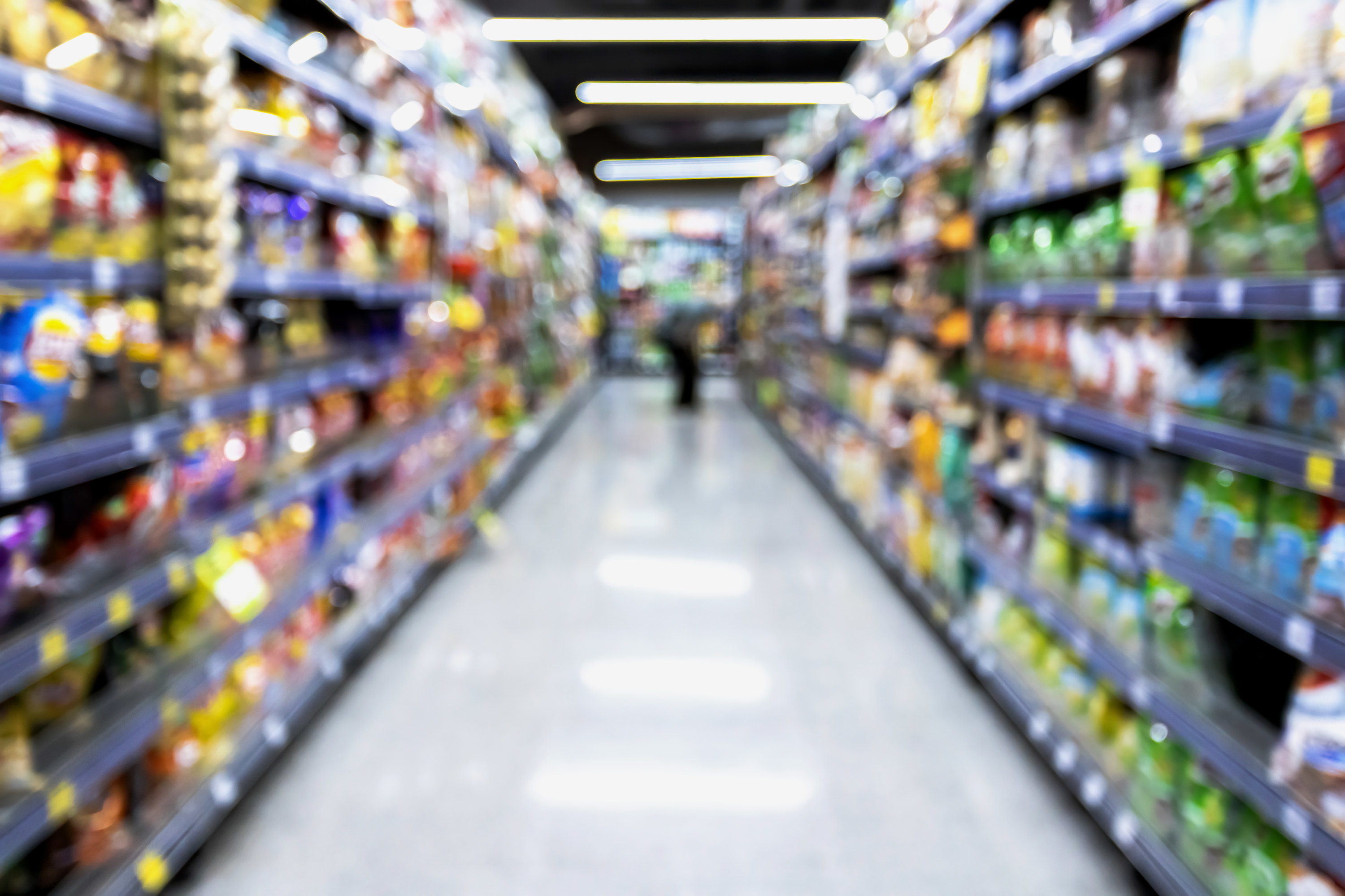 blurry view of a supermarket aisle with snacks
