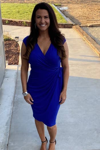 a reviewer wearing the dress in blue
