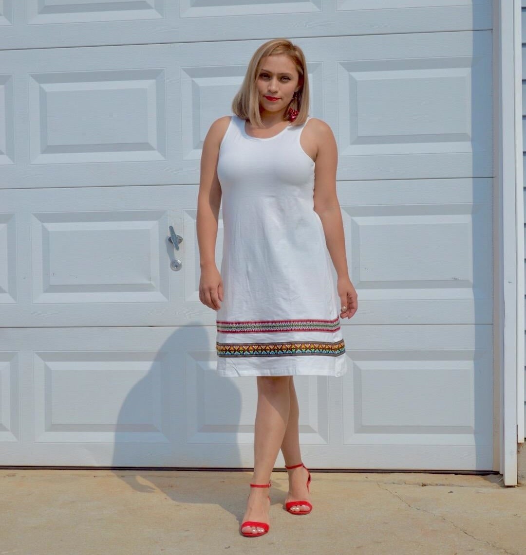 a reviewer wearing the white dress with red heels