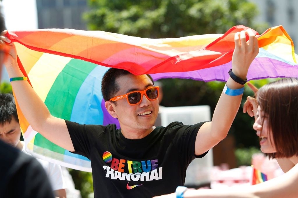 someone holding pride flag for shanghai pride