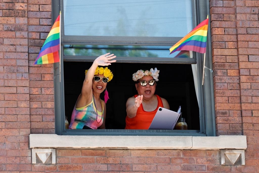 people in window during chicago pride