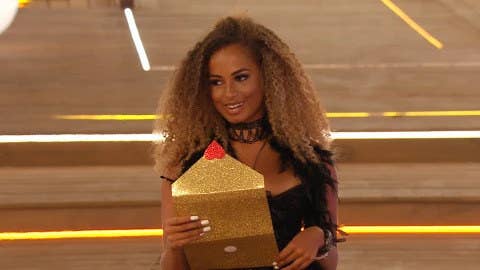 A picture of Amber Rose Gill with a glittery envelope in her hands