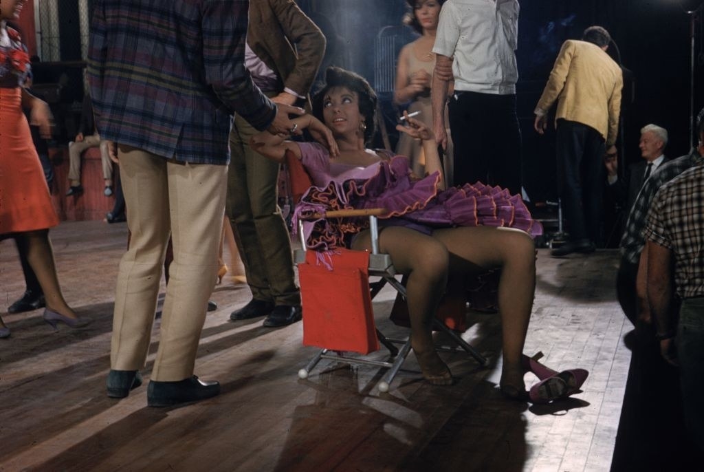 Rita Moreno collapses in a chair for a quiet smoke on the set of the musical West Side Story