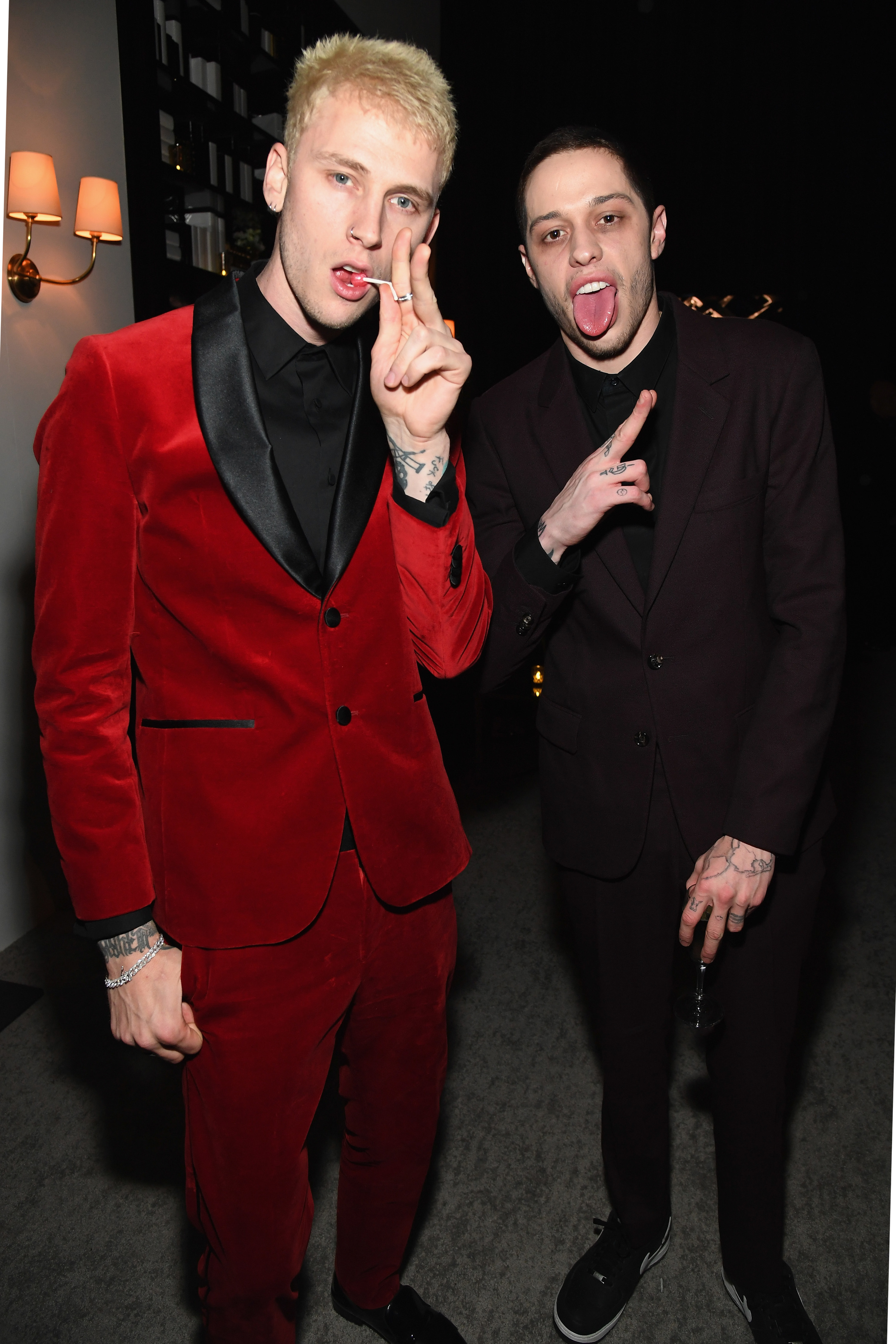 MGK and Pete with their tongues out at a party