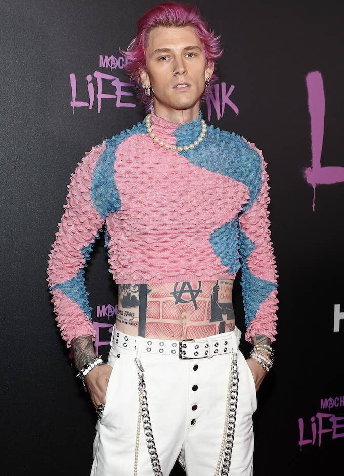 MGK wearing a bright cropped sweater at the premiere of his documentary