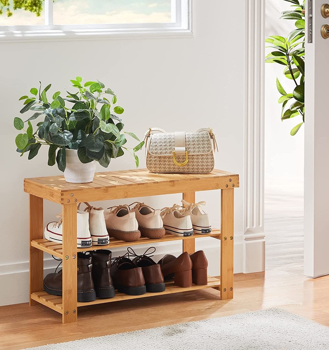 a bamboo shoe rack filled with different kinds of footwear