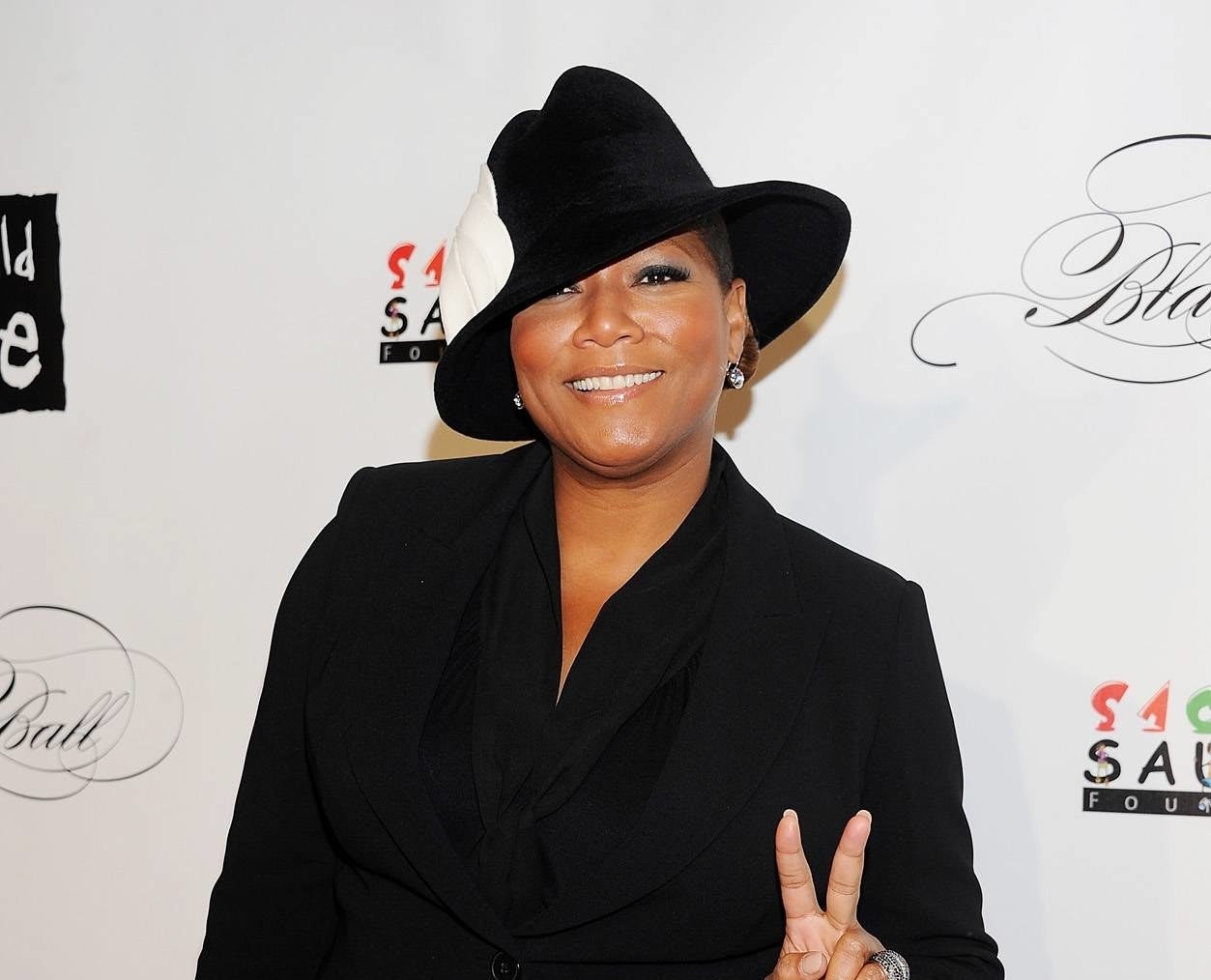 Queen Latifah throwing the peace sign