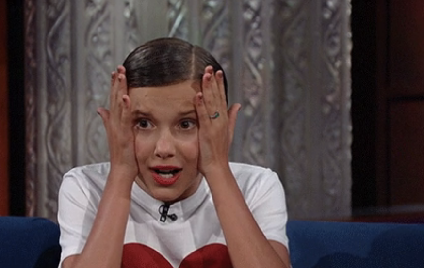 Millie Bobby Brown holding her hands to her face