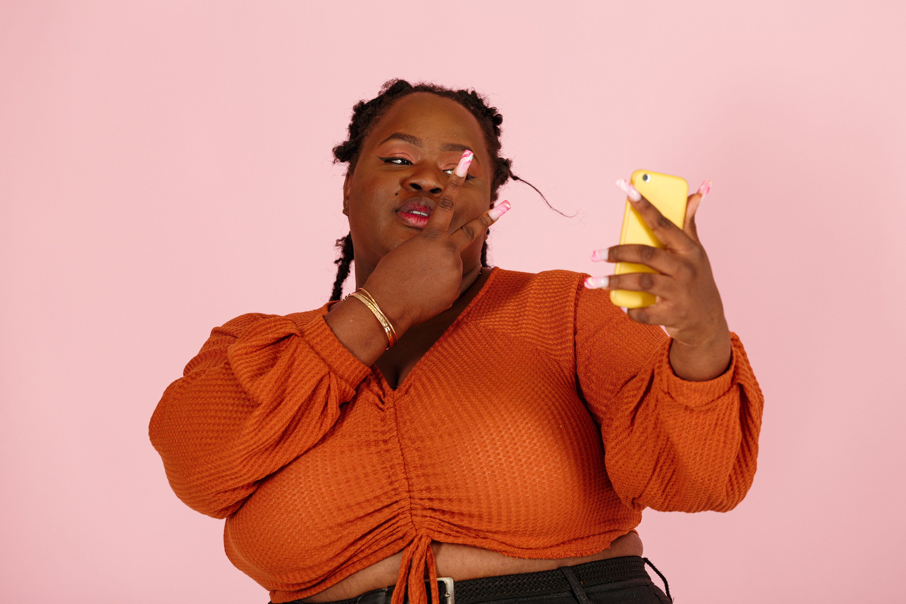 A black, plus sized woman taking a selfie