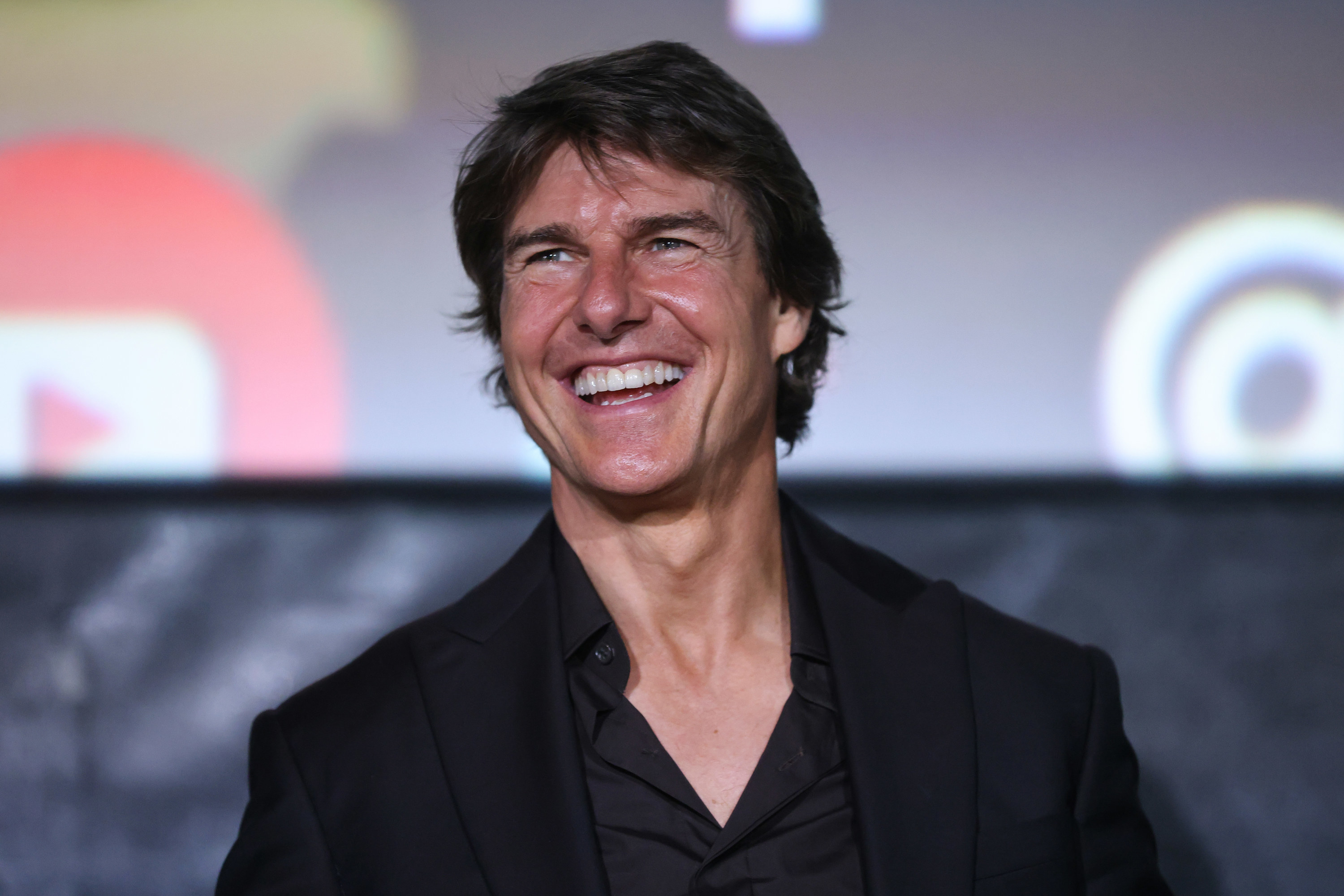 Tom Cruise smiling at the camera, his Roman nose feature is very visible